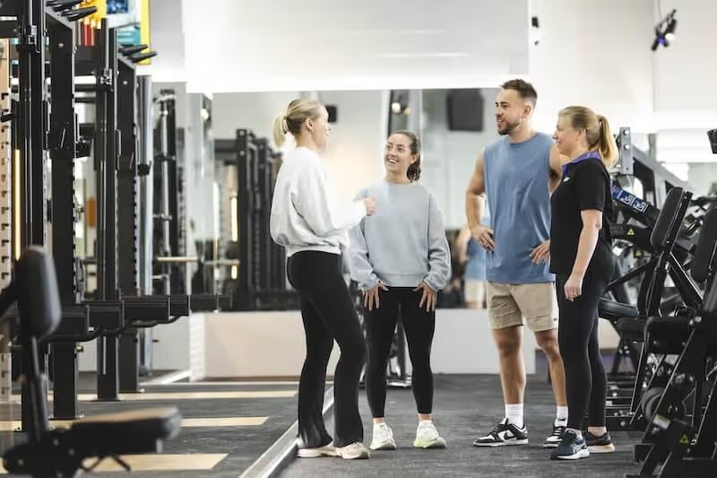 Group of gym members chatting together before a workout at Anytime Fitness Vincentia.