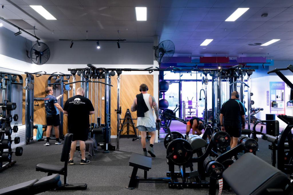 Members using strength and functional training equipment inside Anytime Fitness Vincentia.