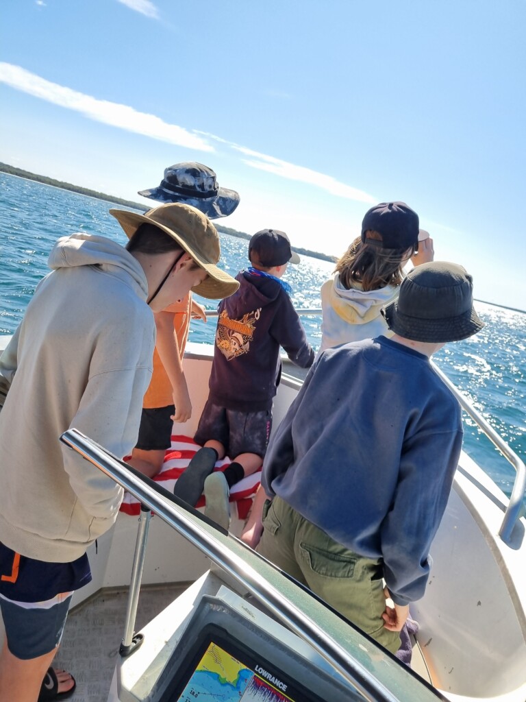 Family enjoying a sunny boat tour across Jervis Bay