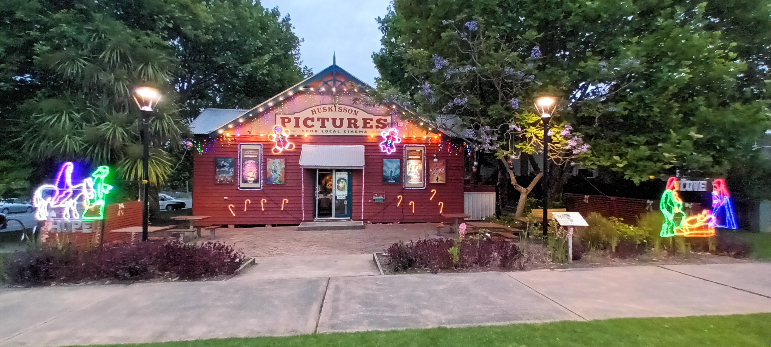 Huskisson Pictures cinema illuminated with colourful lights at night